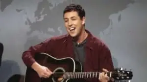 Sandler playing guitar